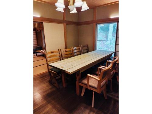 a dining room with a wooden table and chairs at Nasu Kogen Yamagoya - Vacation STAY 29355v in Shiozawa