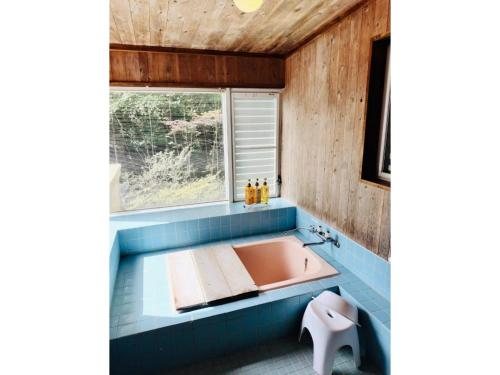 a bath tub in a bathroom with a window at Nasu Kogen Yamagoya - Vacation STAY 29355v in Shiozawa