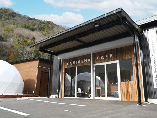 a building with a cafe with a tent in a parking lot at Riverside Glamping Kamiseno - Vacation STAY 92767v in Hiroshima
