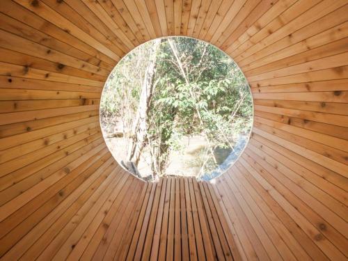 a round window in a wooden sauna at Riverside Glamping Kamiseno - Vacation STAY 92767v in Hiroshima
