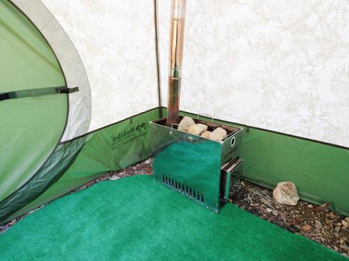 a container of wood inside of a tent at Riverside Glamping Kamiseno - Vacation STAY 92767v in Hiroshima