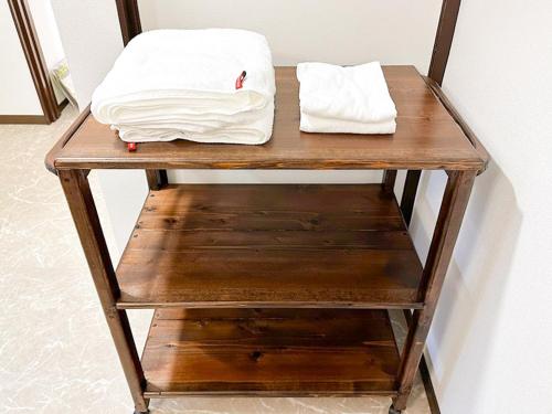 a wooden table with two white pillows on it at Tanabe no Yado Ataigawa - Vacation STAY 10883v in Tanabe