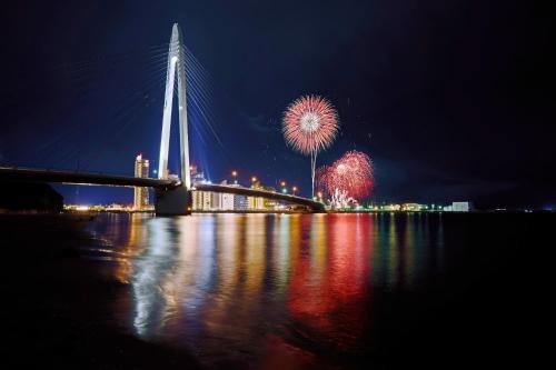 a bridge with fireworks in the sky over the water at HABi-Sekido5 - Vacation STAY 16276 in Wakayama