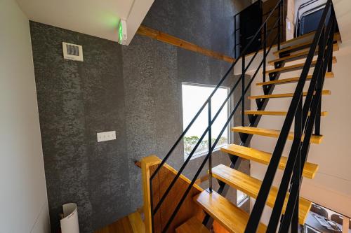 a staircase in a house with black walls at The View Minamiboso - Vacation STAY 16265 in Minamiboso