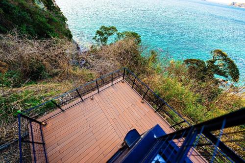 an overhead view of a wooden walkway next to the water at The View Minamiboso - Vacation STAY 16265 in Minamiboso