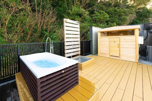 a hot tub on a wooden deck with a building at The View Minamiboso - Vacation STAY 16265 in Minamiboso