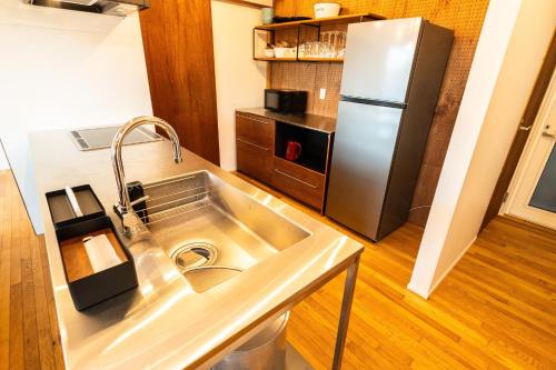 a kitchen with a stainless steel sink and a refrigerator at The View Minamiboso - Vacation STAY 16265 in Minamiboso