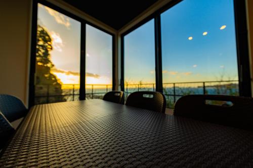 a conference room with a table with chairs and windows at The View Minamiboso - Vacation STAY 16265 in Minamiboso