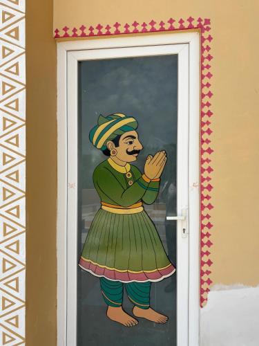 a painting of a woman on a glass door at Chokha Dhaba in Mahwah