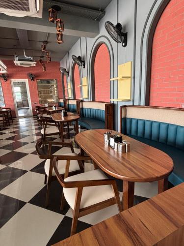 a restaurant with wooden tables and chairs and red walls at Chokha Dhaba in Mahwah