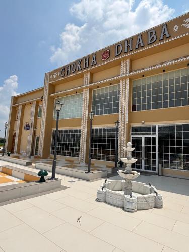 a large building with a fountain in front of it at Chokha Dhaba in Mahwah