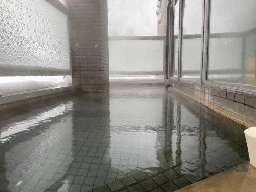 an empty room with a pool of water on the floor at Few Days Condominium Jozankei Room 302 - Vacation STAY 16313 in Jozankei