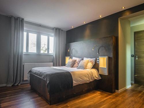 a bedroom with a large bed with two lamps on it at Spacious Stay in Lemberg in Lemberg