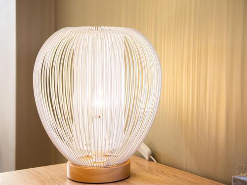 a white lamp sitting on top of a table at Spacious Stay in Lemberg in Lemberg
