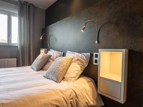 a bedroom with a large bed with two pillows at Spacious Stay in Lemberg in Lemberg