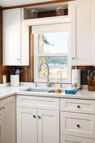 a white kitchen with a sink and a window at Lucky 7 at Lakeshore Resort in Traverse City