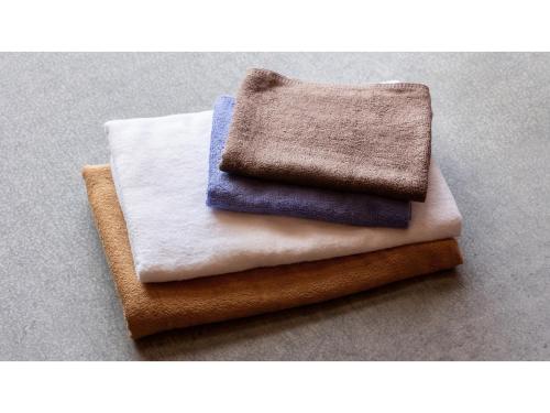 a pile of towels sitting on top of a table at Kurokawa Mori No Kiki - Vacation STAY 14693v in Aso