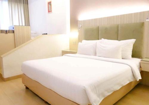Postel nebo postele na pokoji v ubytování Hotel Wisata Niaga