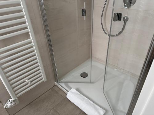 a bathroom with a shower with a glass door at Apartment Relax in Trittau