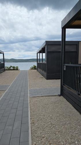 a walkway leading to a building on the beach at Mobile Home Sea Breeze in Sveti Petar