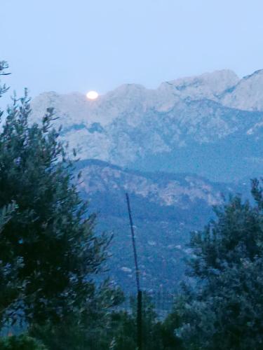 a view of a mountain with the sun in the background at yenivadi in Antalya