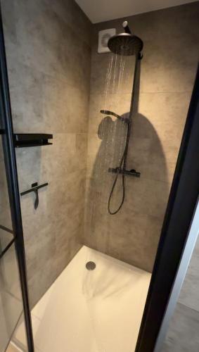 a shower stall with a shower head and a shower at Bed and Breakfast Bij ons in het bos in Bergen op Zoom