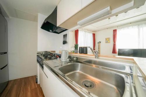 a kitchen with a stainless steel sink and a stove at Ferien - Vacation STAY 16341 in Sapporo