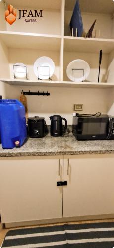 a kitchen counter with a microwave and a toaster oven at JFam Suites, C1-5L 1BR , Up To 7 Pax in Biñan