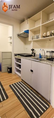 a kitchen with a counter and a rug on the floor at JFam Suites, C1-5L 1BR , Up To 7 Pax in Biñan