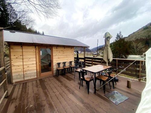 a cabin with a table and chairs on a deck at Unno Glamping - Vacation STAY 27780v in Nantan city