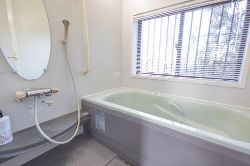 a bathroom with a bath tub and a window at Tokorozawa - House - Vacation STAY 16364 in Tokorozawa