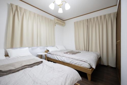 a bedroom with two beds and a window at Tokorozawa - House - Vacation STAY 16364 in Tokorozawa