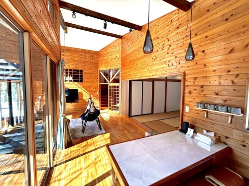 a large room with wooden walls and wooden floors at HARUNA VILLA - Vacation STAY 27961v in Kita-karuizawa