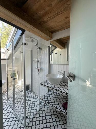 a bathroom with a tub and a shower and a sink at Haus I'mperfect in Stumm