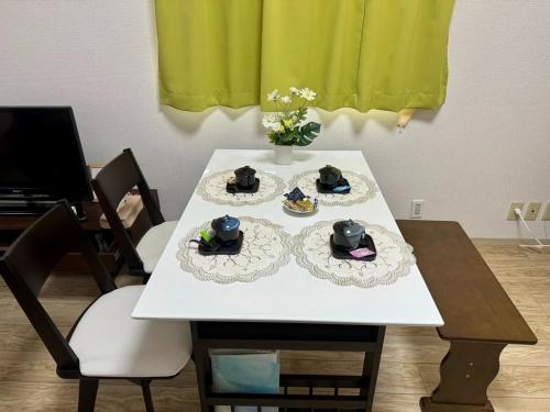 a white table with three plates of food on it at Rainbow takakura - Vacation STAY 16466 in Nagoya
