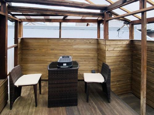 a patio with two chairs and a table with a phone on it at Soratoie Honto - Vacation STAY 39987v in Tadotsu