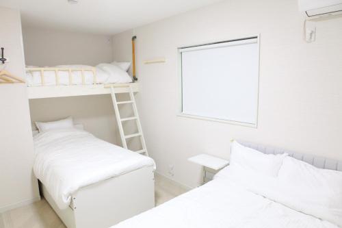 a bedroom with two bunk beds and a ladder at MARINO1 - Vacation STAY 40010v in Fukuyama