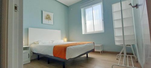 a bedroom with a bed and a window at Guadalimar in Seville