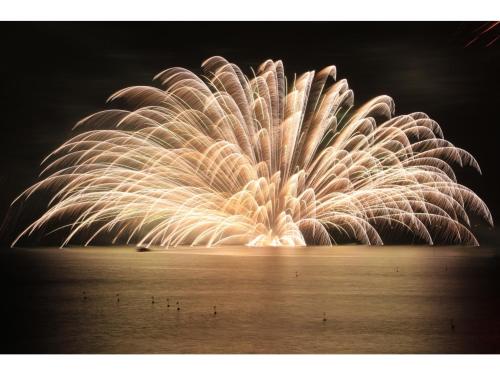 a firework display over the water at night at OCEAN FRONT TATEYAMA - Vacation STAY 66625v in Tateyama