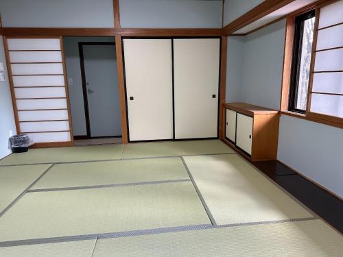 an empty room with doors and a window at GONZOU-HOUSE - Vacation STAY 42967v in Zao