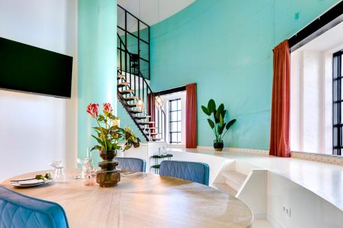 a dining room with a wooden table and blue walls at Hotel Watertoren West in Groningen