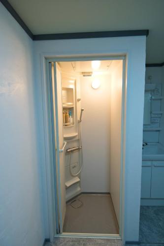an open door to a kitchen with a refrigerator at Ohruri, a camp-style inn where you can enjoy a bon - Vacation STAY 48658v in Iwai