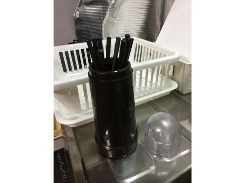 a black vase sitting on a shelf in a refrigerator at KY Apartment - Vacation STAY 40189v in Naha