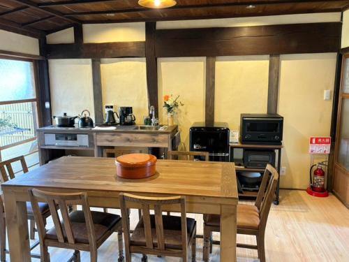 a kitchen with a wooden table with chairs and a dining room at Himeji Castle's inner sanctum 400-year-old - Vacation STAY 16474 in Fukusaki