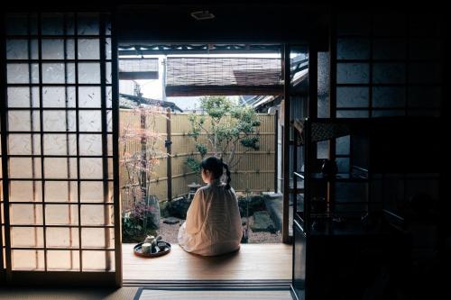 a woman sitting on a porch looking out of a door at Himeji Castle's inner sanctum 400-year-old - Vacation STAY 16474 in Fukusaki