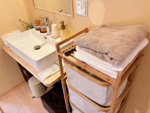 a bathroom with a sink and a counter with towels at Himeji Castle's inner sanctum 400-year-old - Vacation STAY 16474 in Fukusaki