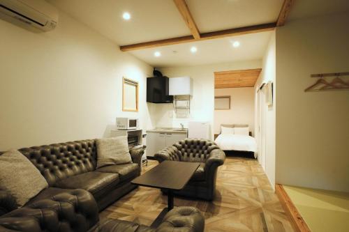a living room with a couch and a bed at RUSH Awajiso - Vacation STAY 56534v in Awaji