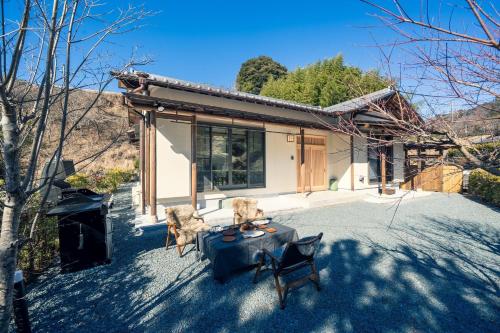 a house with a table and chairs in front of it at Midori-an - Vacation STAY 56541v in Kikugawa