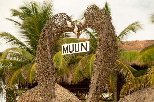 a sign in the shape of an eagle with the word mummy at MUUN Beach Club in Ciudad del Carmen