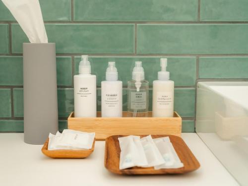 a bathroom with four bottles of soap and towels at Buena Vista Tokachi - Vacation STAY 47319v in Obihiro